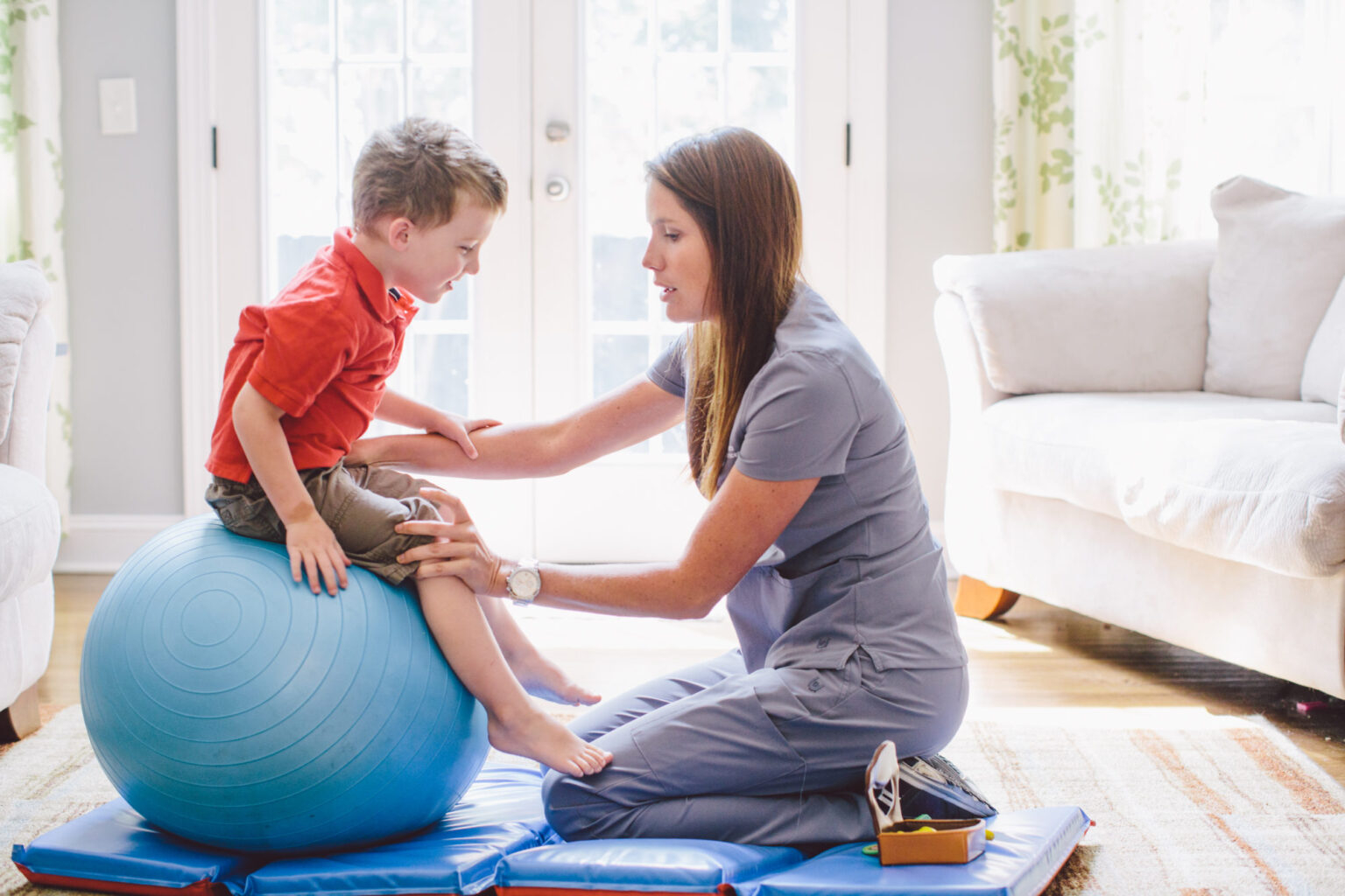 How do paediatric physiotherapists help improve balance and mobility skills in young children?